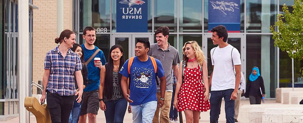 A group of friends walking in front of the Jordan Student Success Building