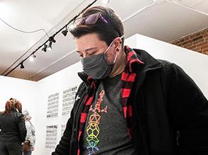 Photo of Alumni Artist, with mask in studio