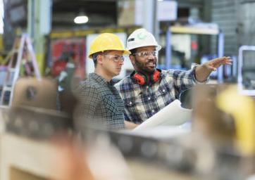 Two construction workers discussing project