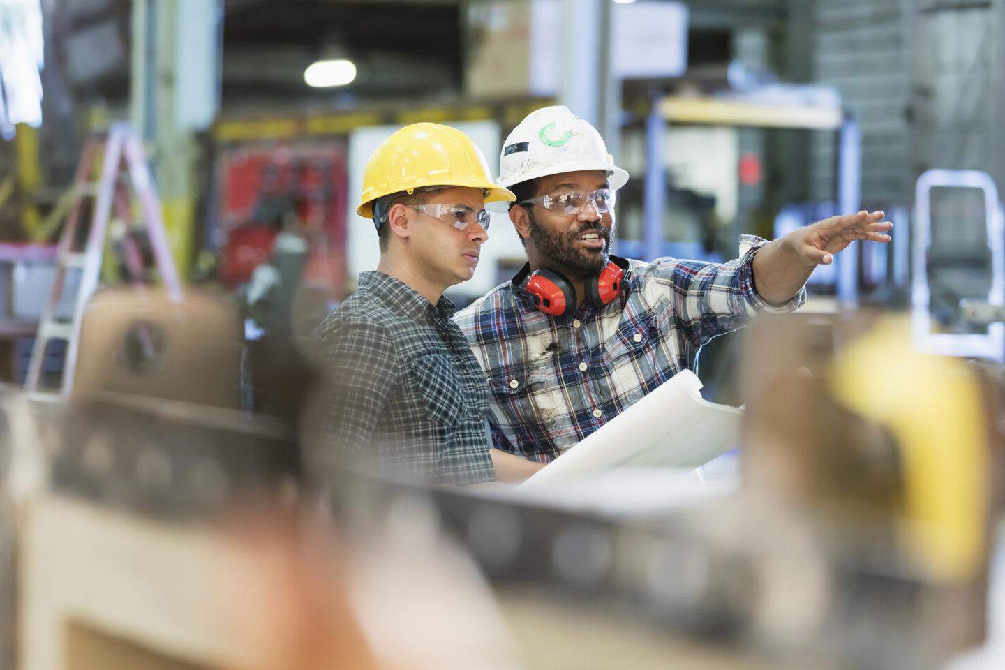 Two construction workers discussing project