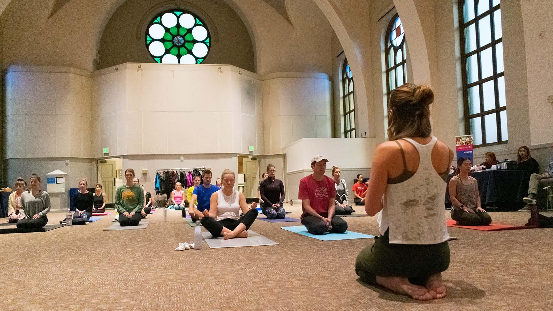 MSU Denver staff and students do yoga in St. Cajetans.